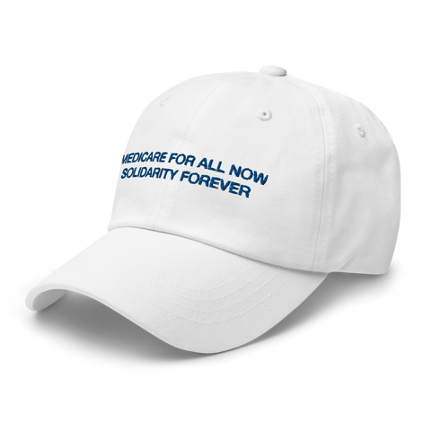 Three-quarters front view of white cotton baseball cap with blue sans-serif letters in all caps reading "Medicare for all now" on the first line, "Solidarity Forever" on the second line
