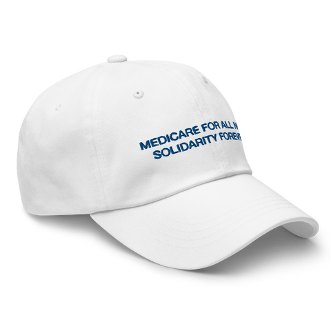 Alternate three-quarters frontal view of white cotton baseball cap with blue sans-serif letters in all caps reading "Medicare for all now" on the first line, "Solidarity Forever" on the second line