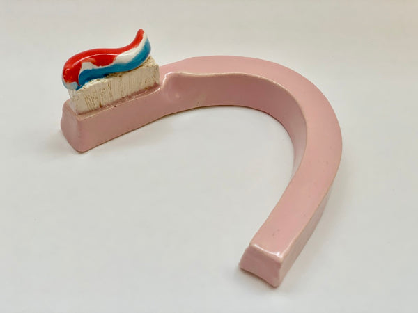 Seth Bogart: Pink Curved Toothbrush